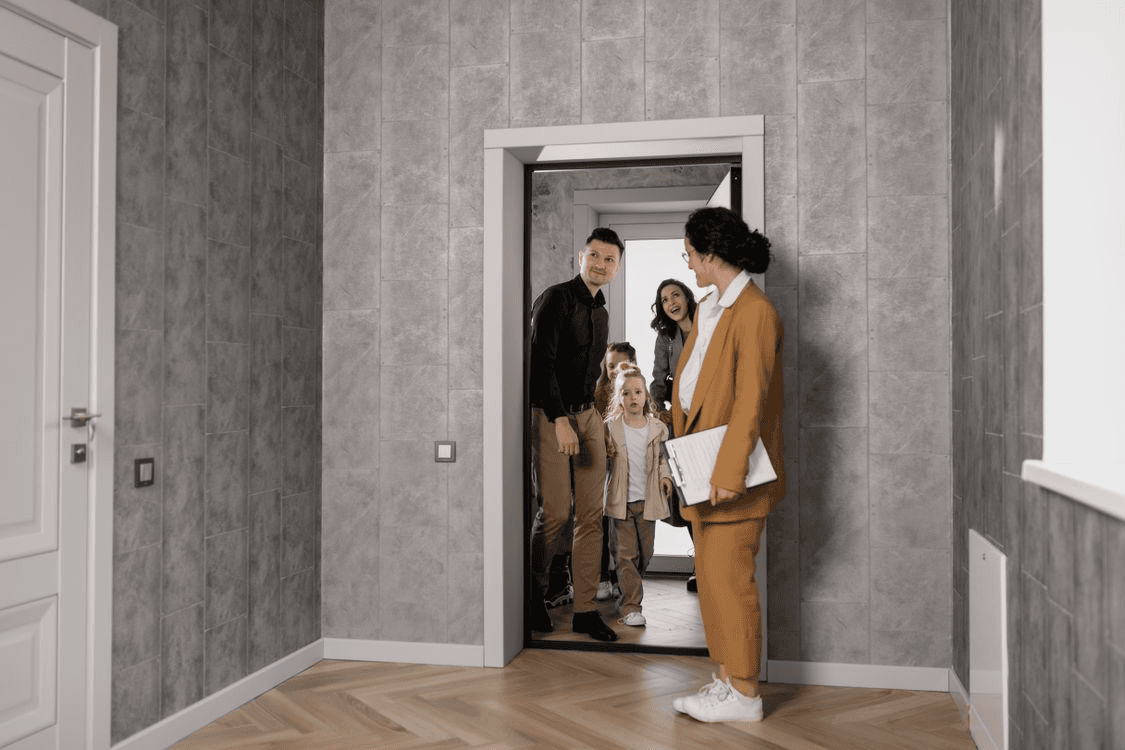 Family touring an apartment with a real estate agent